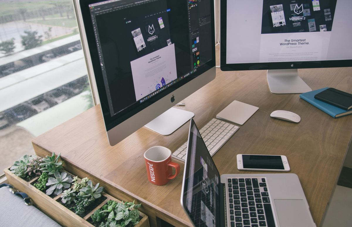 Software developer working across multiple screens